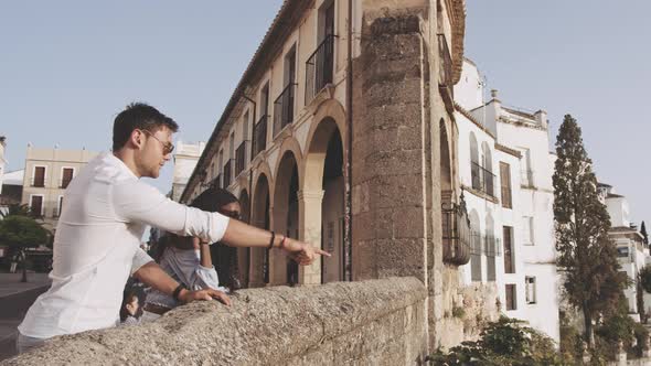 Young Tourist Couple At Walls Of Ronda