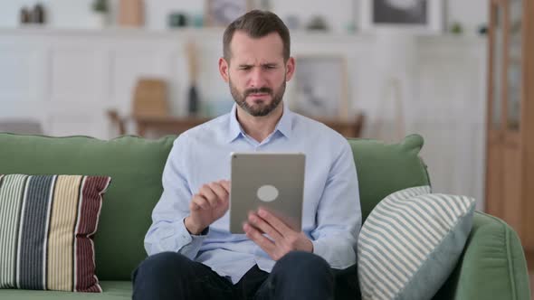 Young Man Reacting to Failure on Tablet