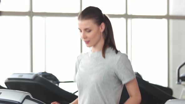 Cheerful Woman Doing Cardio Exercise at Gym.