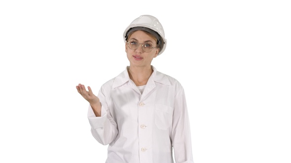 Mature engineer woman in hard hat and lab coat talking