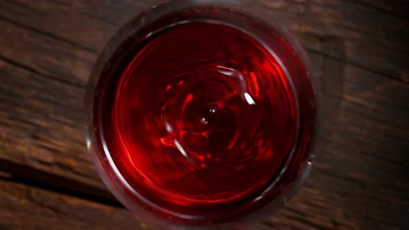 Super Slow Motion Macro Shot of Dripping Droplet Into Filled Glass of Red Wine at 1000Fps