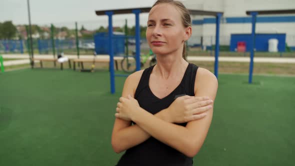 Fit Woman Trains Her Abdominal Muscles While Lying on Wooden Boards in the Open Air