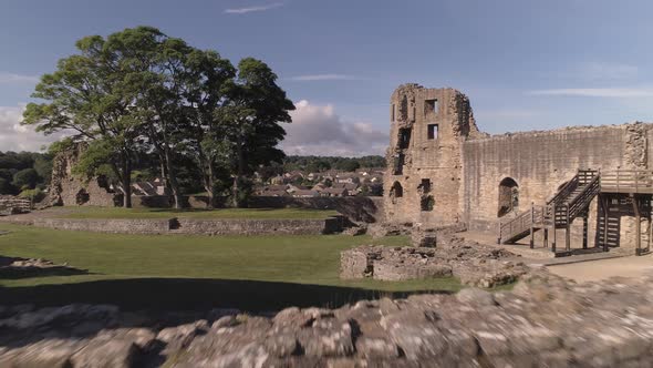 Barnard Castle in Teesdale, County Durham. Aerial shot in a zoom, dolly style, across the ruins from