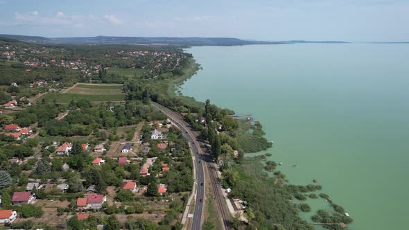 Aerial view of Lake Balaton, road, houses, fields and gardens in Hungary