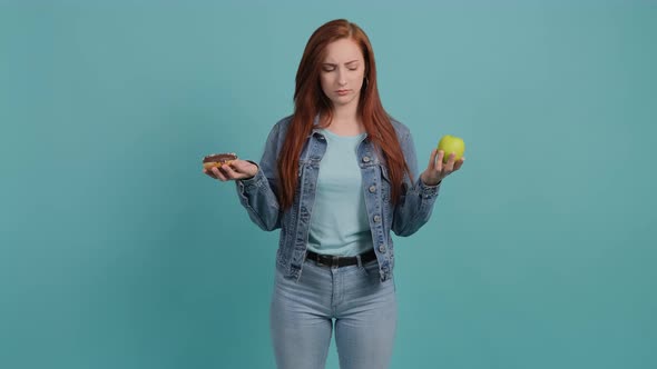 Young Woman Choosing Between Apple and Donut, the Girl Is Confused in Her Choice