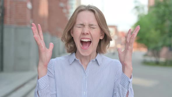 Portrait of Attractive Woman Screaming Shouting