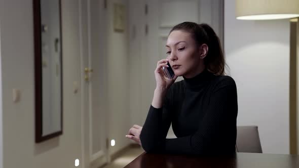 Woman Is Calling By Mobile Phone and Waiting for Answer Long Sitting Alone at Home