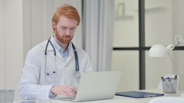 Redhead Male Doctor Smiling at Camera