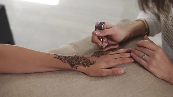 Applying Henna on Hands.