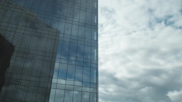 Timelapse of Clouds Moving and Reflecting in Glassy Skyscraper