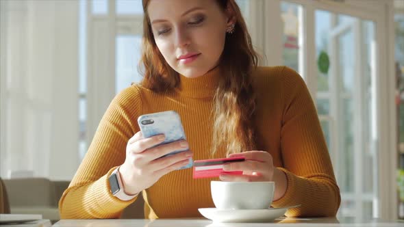 Beautiful Sunny Day Young Woman Drinks Morning Coffee in a Cafe, Making Online a Purchase Easy