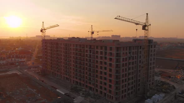 Construction Site in the Middle of the City and Private Houses at Sunset