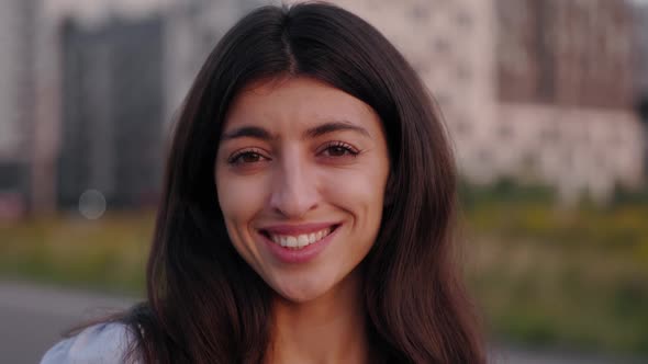 Close Up Portrait of Young Brunette Woman at the Suburb Street in Summer Evening with Modern