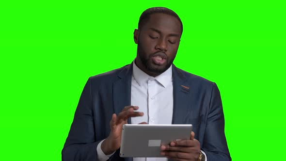 Successful Businessman Using Digital Tablet on Green Screen.