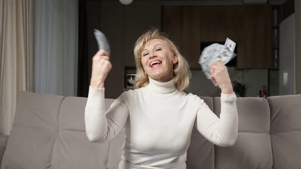 Middle Aged Woman Tosses Bills of Pension in Air of Room