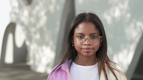 Portrait of Calm Serious Young African American Latin Teenager Woman Wearing Glasses and Looking to