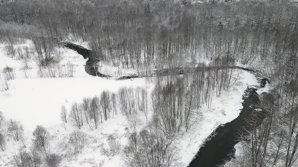 Majestic Winter Landscape with a Small River Aerial View