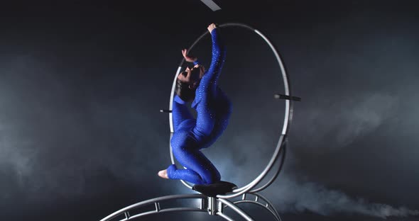 Professional Gymnast is Performing in a Spinning Hoop Studio Show