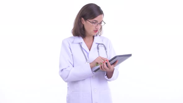 Happy Beautiful Woman Doctor Talking While Using Digital Tablet