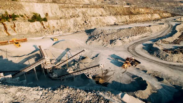 Excavator Loads Rock Into a Dump Truck