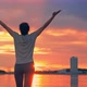 Caucasian Woman in Sport Clothes Raising Arms to the Sky at Sunset - VideoHive Item for Sale