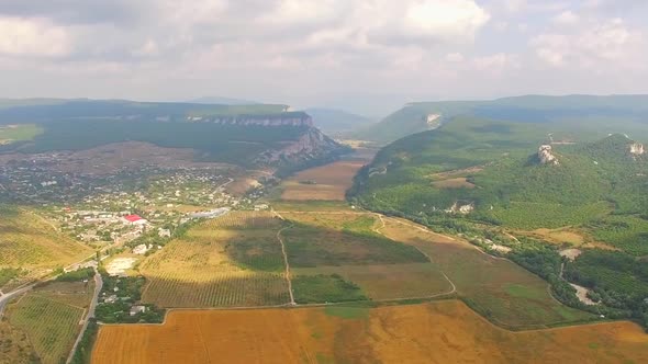 Landscape Flight through the Field and the Village to the Mountains