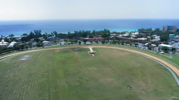 Aerial drone camera approaching the gate of Garrison Savannah racecourse in Bridgetown, Barbados