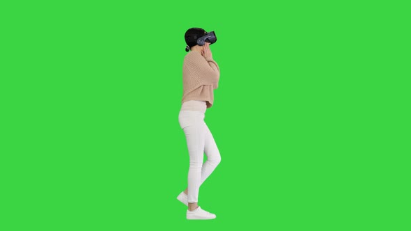 Beautiful Lady with Brunette Hair Walking and Using VR on a Green Screen, Chroma Key