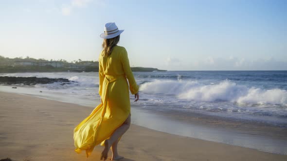 Traveler Tourist Walking By Beach Scenic Splashing Ocean Waves at Golden Sunset