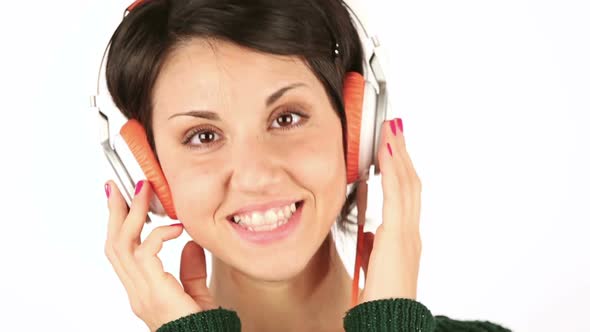 Smiling Young Woman Listening Music with Headphones