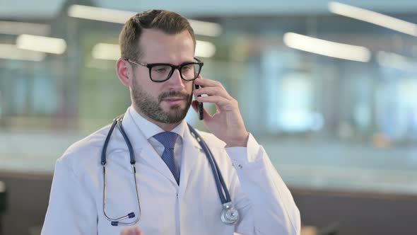 Portrait of Young Male Doctor Talking on Smartphone