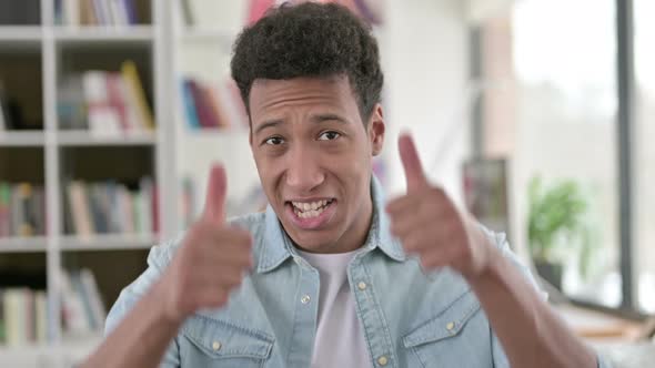 Thumbs Up By Cheerful Young African American Man 