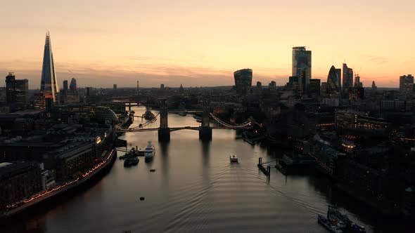 Aerial view of London, River Thames and Tower Bridge just after the sun has set and the sky is lit.