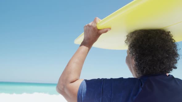 Senior woman with a surfboard