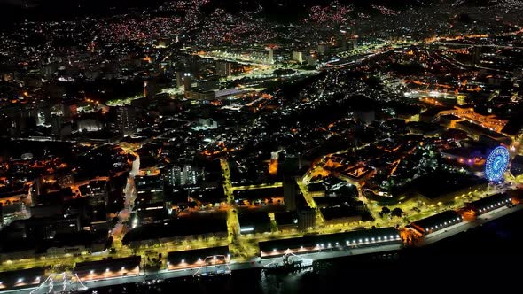 Night panoramic landscape of illuminated ferris wheel at Rio de Janeiro Brazil