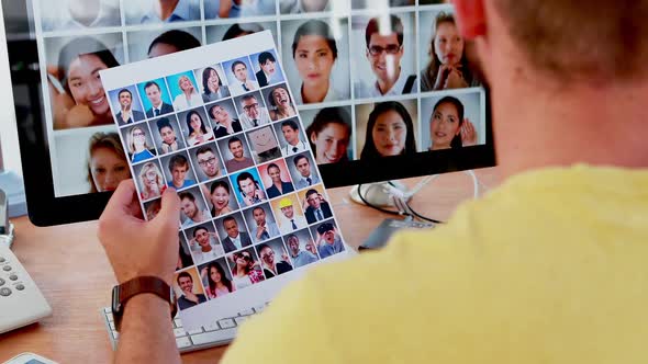 Male executive looking photos on computer at desk 4k