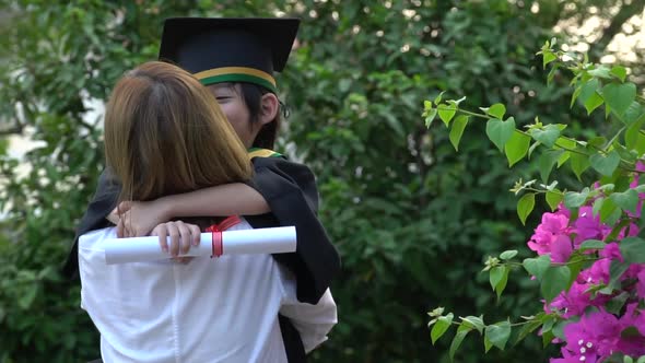 Asian Mother Embracing Her Son On Graduation Day