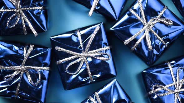 Blue Gift Boxes on Blue Color Background. Christmas and New Year Rotating Backdrop. Present