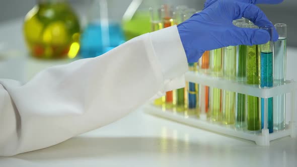 Lab Assistant Checking Sediment in Tube With Blue Liquid, Washing Substance