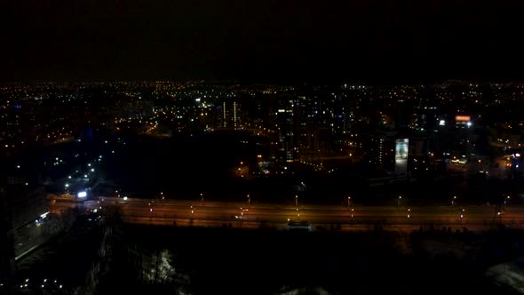 Cars driving lighted street in night Kharkiv city