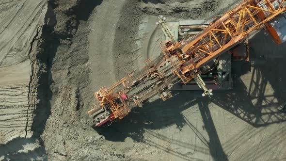 Aerial View of Bucket Wheel Excavator in Process of Mining Natural Resource. Heavy Industry.