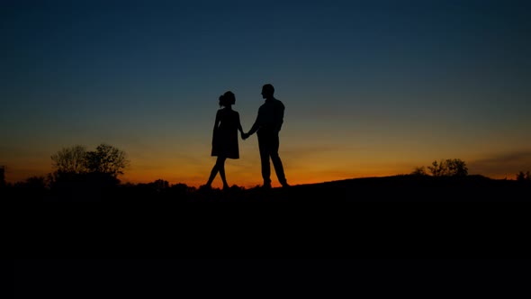 Lovers on Sunset Background