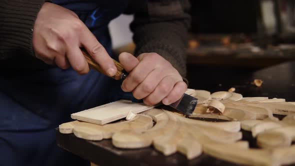 Slow Motion of Carpenter Working on a Wooden in His Workshop on the Table Preparing a Detail of