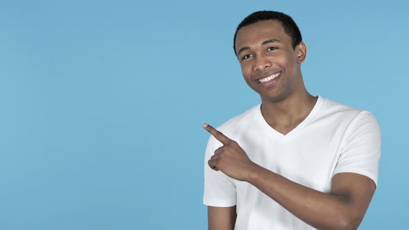 African Man Pointing with Finger on Side