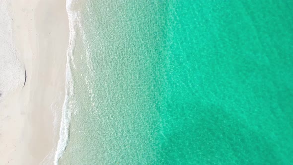 Aerial video beautiful closeup shot beach and seawater on crystal water wave on sand in sunset time