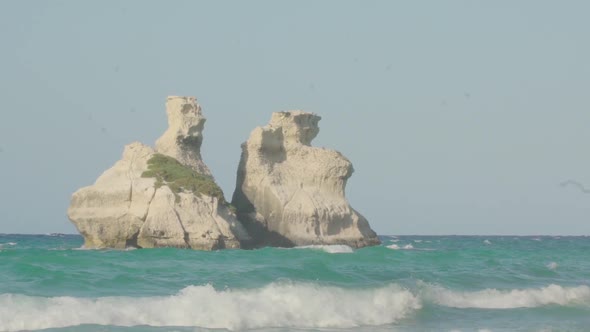 Slowmotion close up shot of the two sisters (Le due sorelle) at the beach in Apulia (South Italy) wi