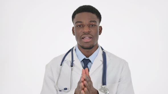 African Doctor Talking on Online Video Chat on White Background