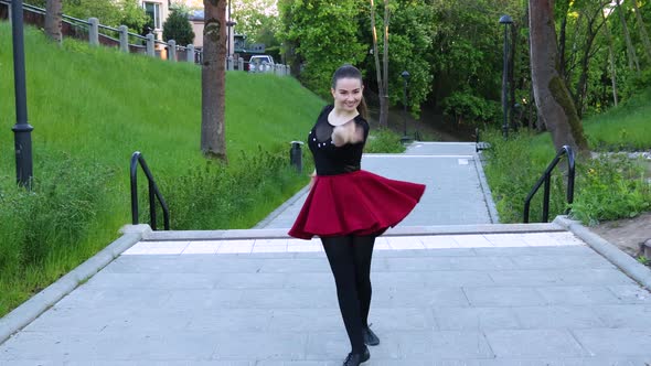 Female dancer performs an energizing dance outside