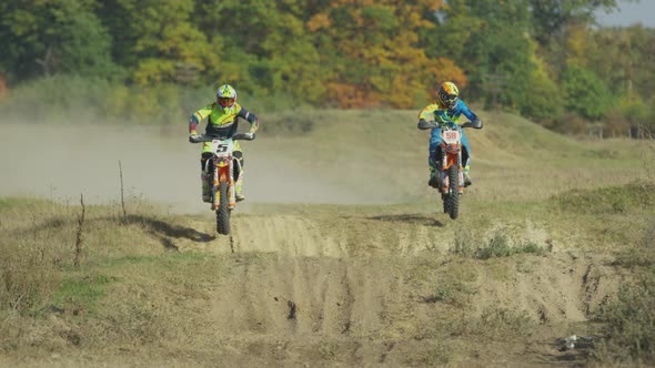 Riders doing stunts on motocrosses