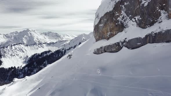 Aerial drone shot on montain rock in the alps, Austria, Kleinwalsertal, skiing area, snowy mountains